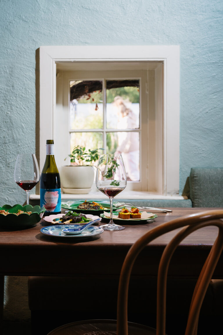 Food and Aphelion wine by the window — photograph by Meaghan Coles