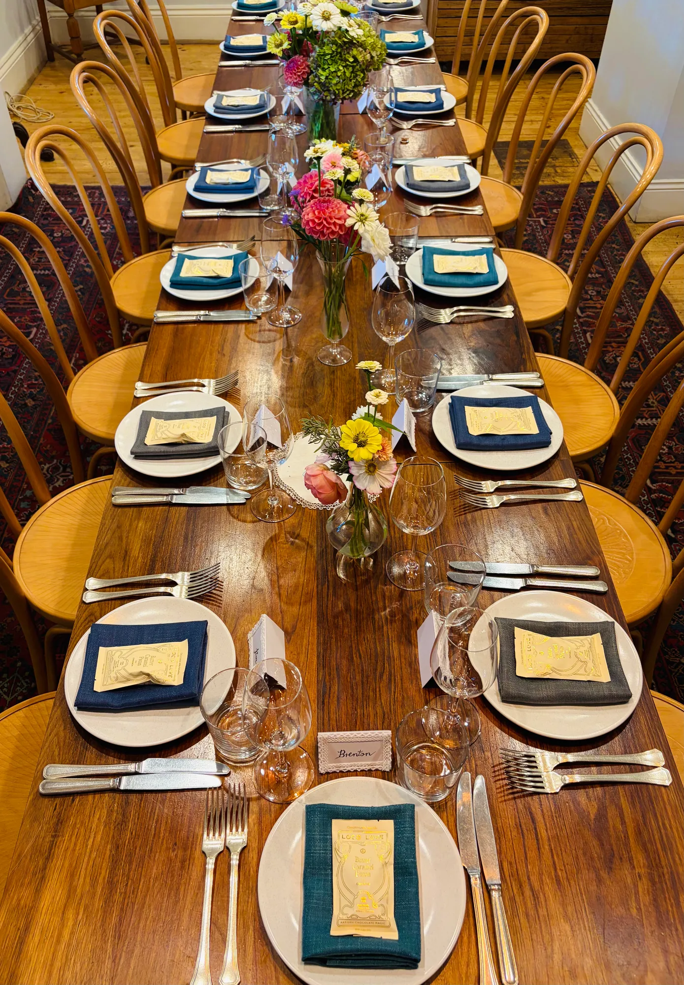 A long dining table set with flowers, glassware and place settings at The Salopian Inn