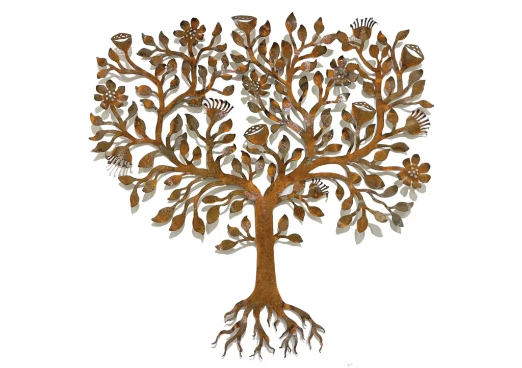 A metal tree artwork with leaves and flowers casting shadows