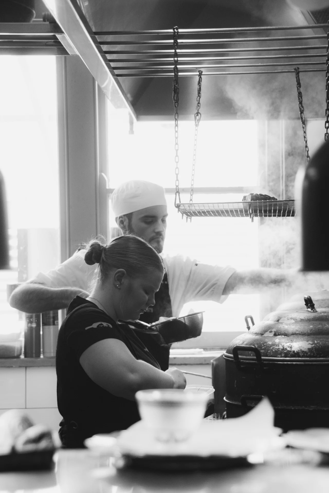 Brittany and Michael working together at the stove in the Salopian Inn kitchen