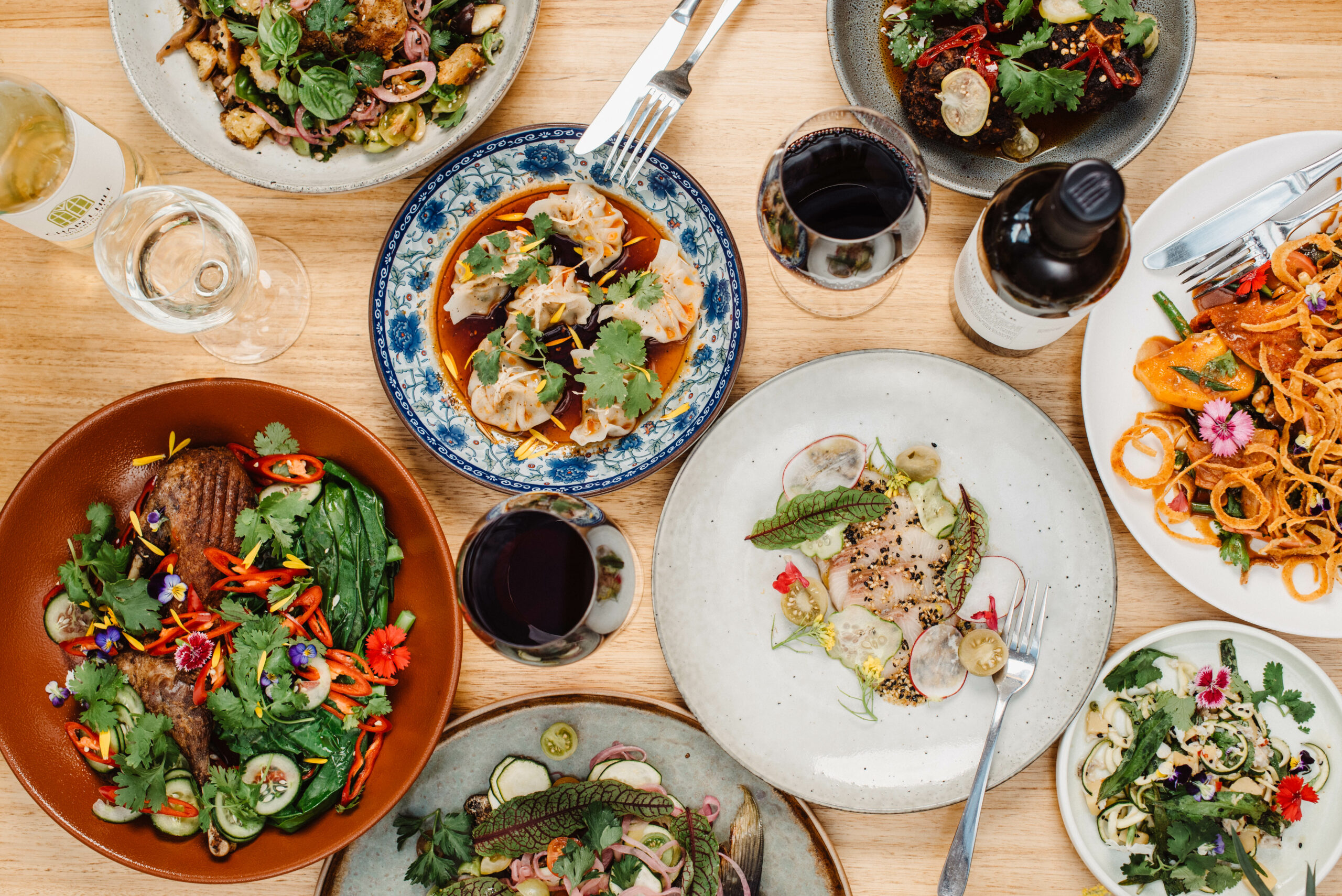 A shared spread of Salopian Inn dishes and wine photographed by Meaghan Coles