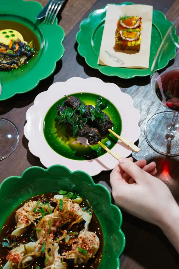 Shared dishes and red wine on a dining table at The Salopian Inn.